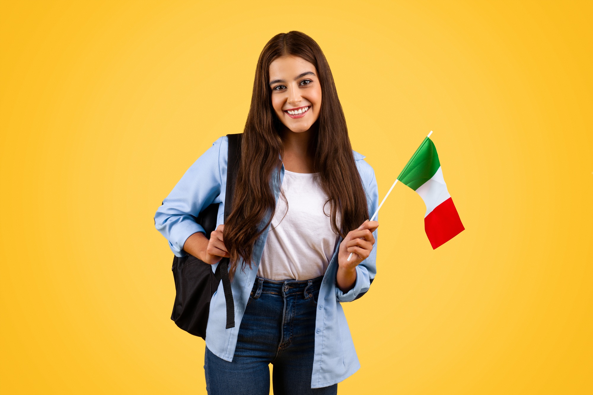 Smiling european teenager student pupil, with Italian flag, enjoy exchange study, courses